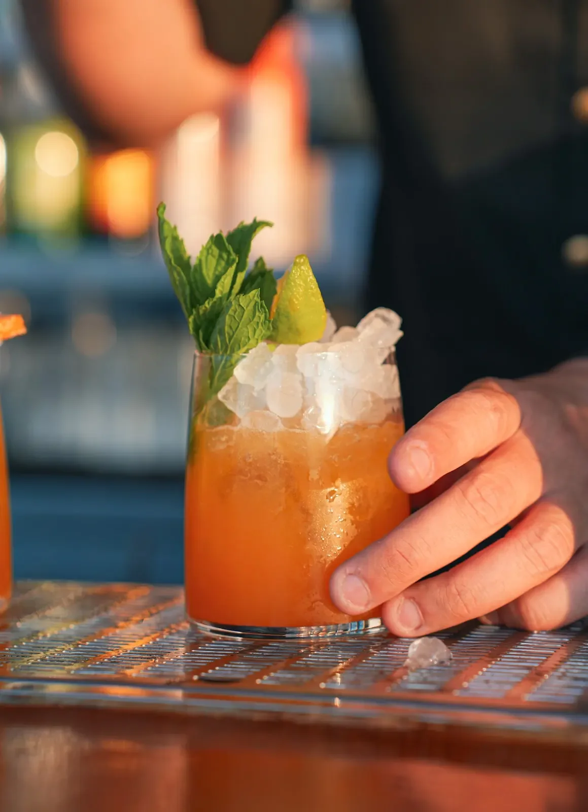 A citrus cocktail held at the bar