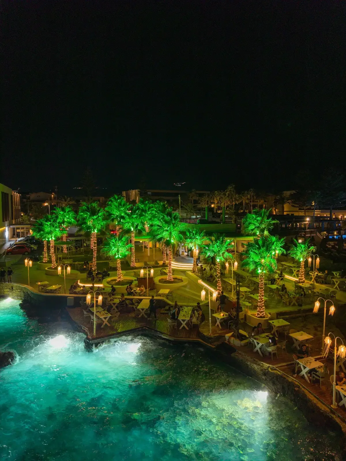Thalassa’s waterfront terrace glowing after dark