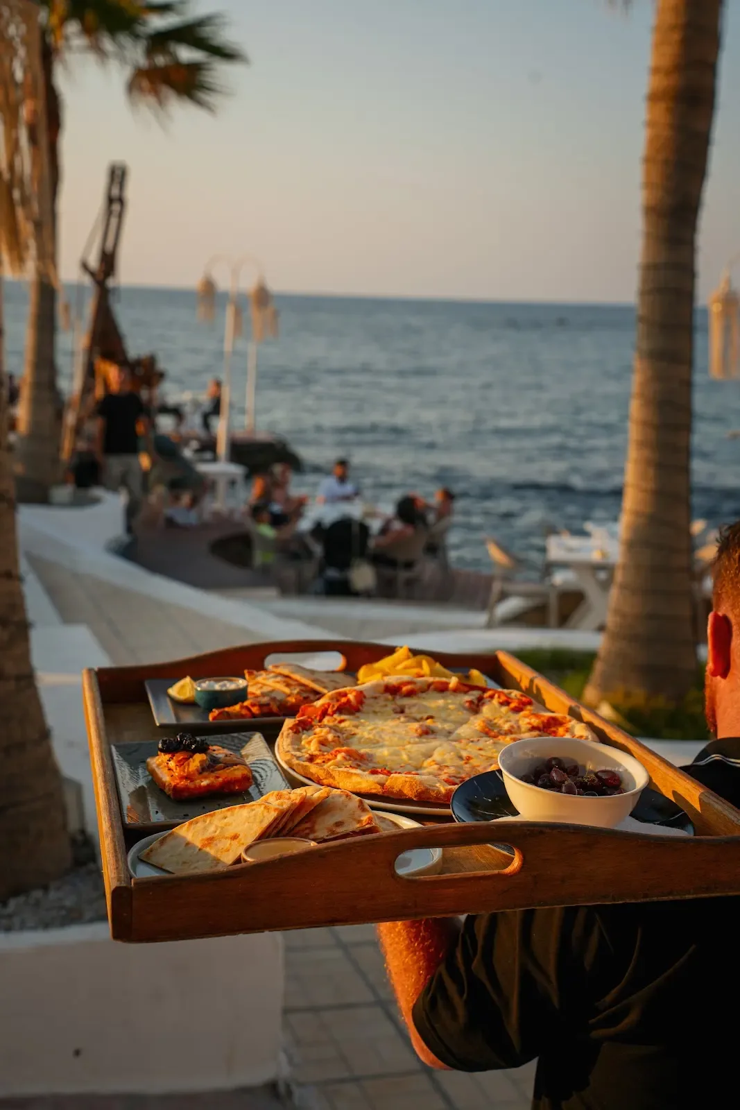 A platter carried beside the sea at sunset