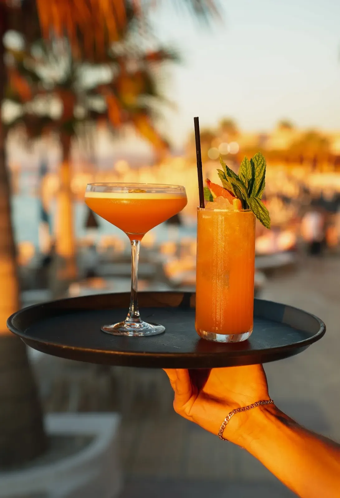 Cocktails set against the sunset at Thalassa